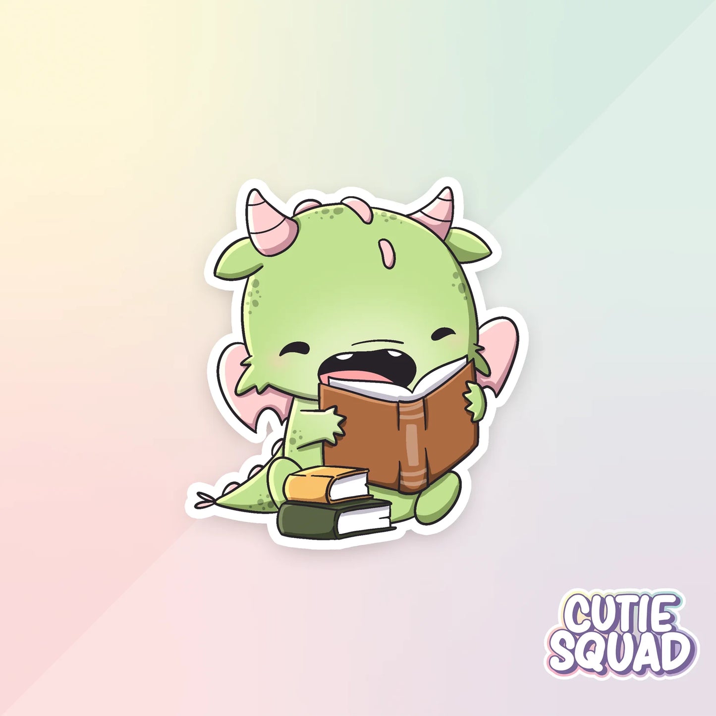 bookdragons sticker van cutiesquad met stapeltje boeken en lezend